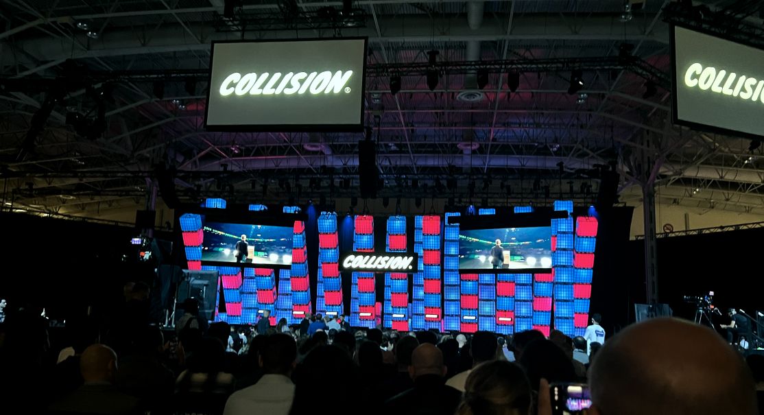 Colorful screens with videos of the Collision Conference.